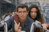 A man and woman handcuffed together steer a motorcycle in Tomorrow Never Dies