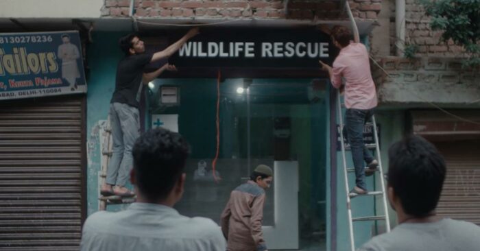 Wildlife rescuers put up a Wildlife Rescue sign on their Delhi property in the film "All That Breathes."