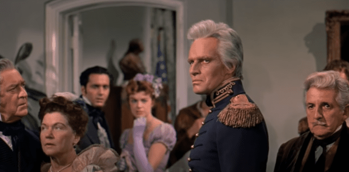 Heston as Andrew Jackson, staring silently in a roomful of onlookers.