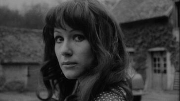A brunette woman faces the camera in a still from A Woman Kills.