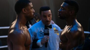 Two boxers listen to referee's instructions in Creed III