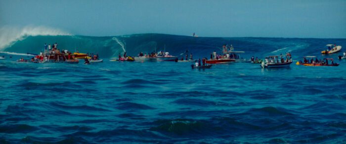 In Pacifiction, numerous small watercraft positioned to watch a surfer atop a giant wave.