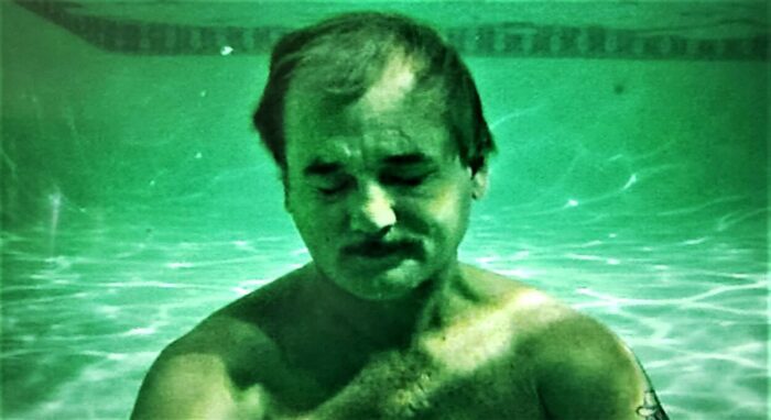 Bill Murray as Herman Blume in Rushmore, floating underwater in a swimming pool.