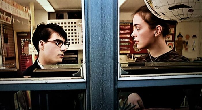 Jason Schwartzman and Olivia Williams framed in divided windowpanes, an example of the visual storytelling in Rushmore