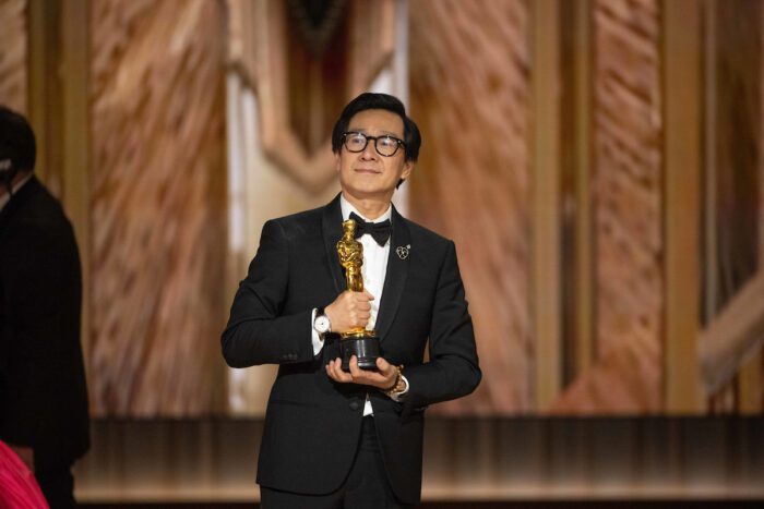 Ke Huy Quan onstage while Jonathan Wang accepts the Oscar® for Best Picture during the live ABC telecast of the 95th Oscars® at the Dolby® Theatre at Ovation Hollywood on Sunday, March 12, 2023. 