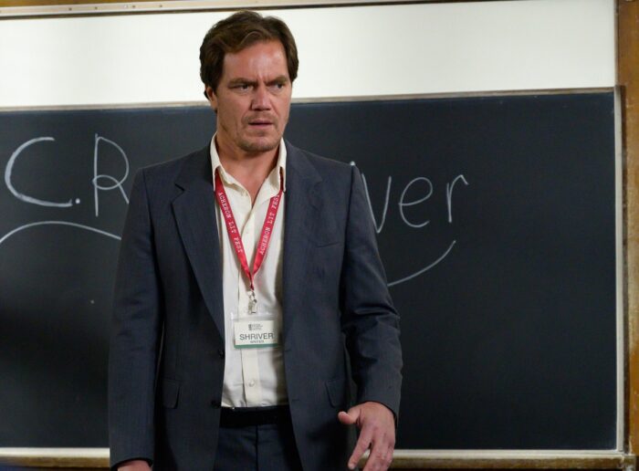 Michael Shannon as Shriver speaks in front of a blackboard.