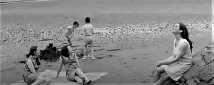 Black and white scene on a beach featuring several young ladies and some boys, taken from the 1967 adaptation of Ulysses by James Joyce