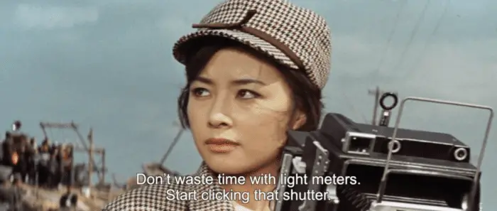 Junko Nakanishi in "Mothra vs Godzilla" in a matching checkered hat and coat.