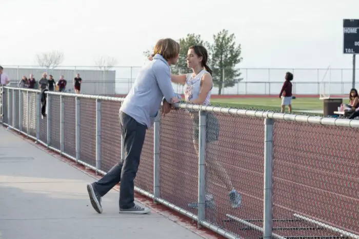 Ethan and Be embrace at a track practice.