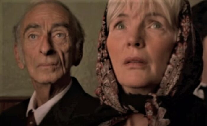 Fionnula Flanagan and David Kelly as Annie O'Shea and Michael Sullivan, two older folks in church for a funeral in the 1998 Irish comedy Waking Ned Devine.