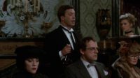 A host walks around a table of guest in Clue