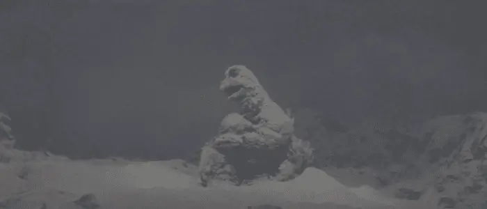 Godzilla and Minilla holding each other as they freeze into hibernation in "All Monsters Attack"