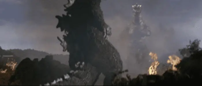 Godzilla getting back up in the foreground while Mechagodzilla waits in the background in "Godzilla vs. mechagodzilla"