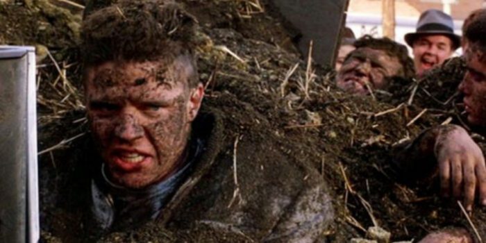Biff glaring, covered in manure alongside his friends in his car