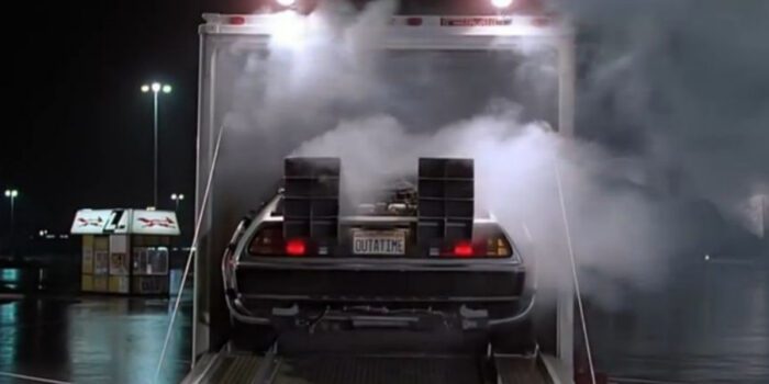 The DeLorean's first appearance backing out of a truck with smoke around it