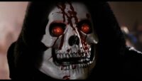 A white skeleton mask with red eyes has blood on the face.