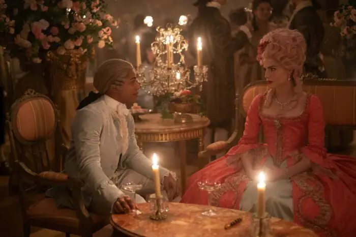 Kelvin Harrison Jr. and Lucy Boynton in the film CHEVALIER. Wearing powdered wigs and the finest fashion of France circa 1789. Photo by Larry Horricks. Courtesy of Searchlight Pictures. © 2023 20th Century Studios All Rights Reserved.