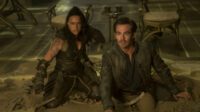 Chris Pine plays Edgin and Michelle Rodriguez plays Holga crouching out of sight preparing to attack in Dungeons and Dragons; Honor Among Thieves