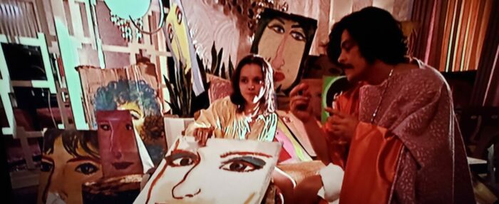 Christina Ricci as Lucy with Benicio del Toro as the leering Dr. Gonzo nearby in Fear and Loathing in Las Vegas.
