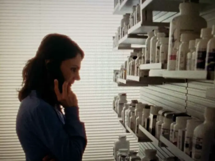 Annie Parisee as Diana in a room full of pill bottles. Giving Birth to a Butterfly (2021)