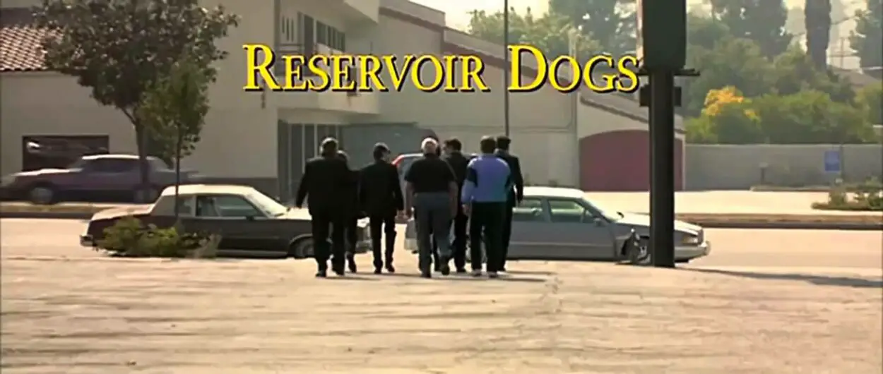 The Reservoir Dogs walking with their backs to the camera and the title card above their heads.
