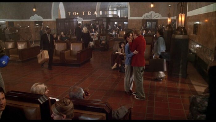 Preston Meyer and Amanda Beckett share a kiss in a train station in Can't Hardly Wait.