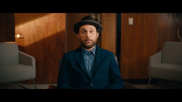 Charlie Day in bowler hat and a simple suit with no tie, portraying Latte Pronto in Fool's Paradise, courtesy of Roadside Attractions