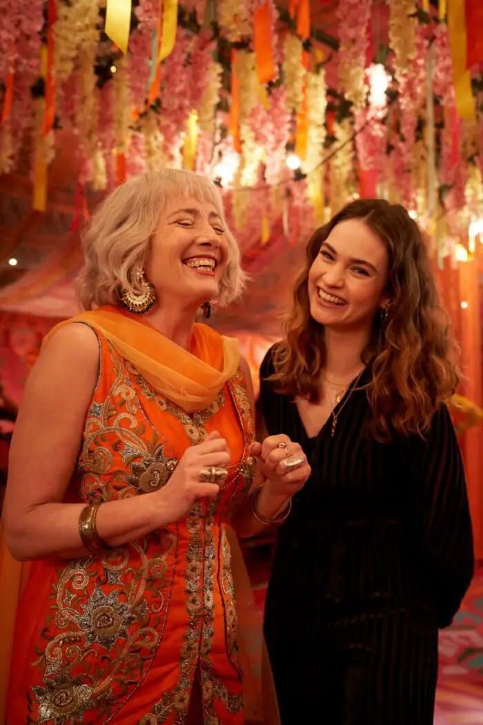 A mother in ceremonial dress smiles next her daughter in What's Love Got to Do With It?