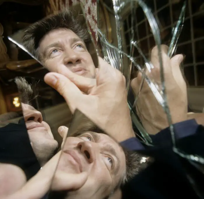 A cracked mirror shows several David Lynchs in Lynch/Oz. 