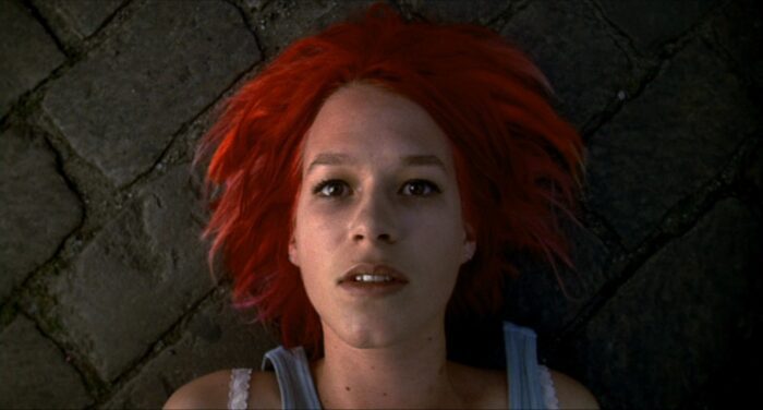A dying Lola looks up from the ground in shock in Run Lola Run