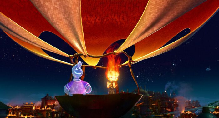 Ember and Wade ride in a red and white hot hair balloon propelled by Ember's fire element at night.