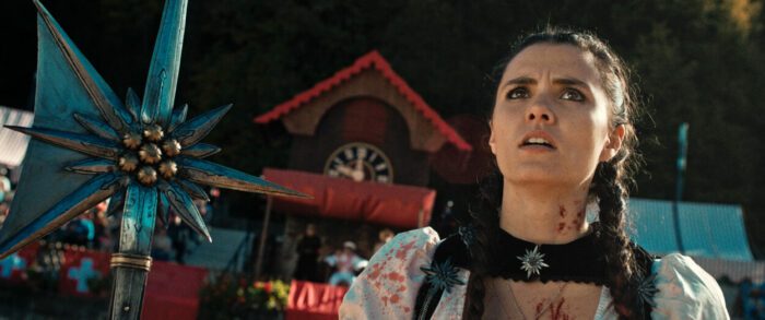 Still from the film MAD HEIDI showing Heidi (Alice Lucy) holding a large axe.