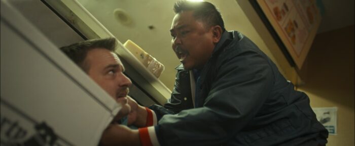 Derek Basco and Micah Stock as Tommy T. and Jay moore in Maggie Moore(s) (2023). From Screen Media Films.