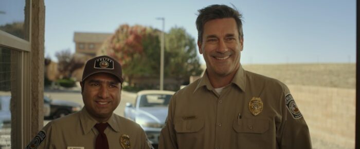 Jon Hamm and Nick Mohammed as Sheriff Sanders and Deputy Reddy in Maggie Moore(s) (2023). From Screen Media Films.