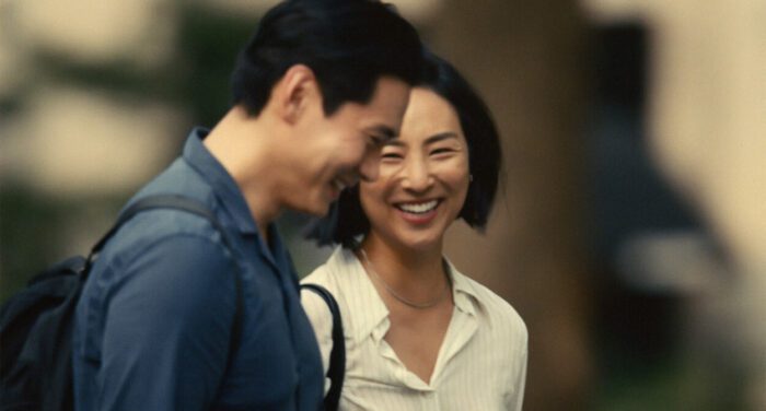 Hae Sung (Teo Yoo) and Nora (Greta Lee) laugh during the day.