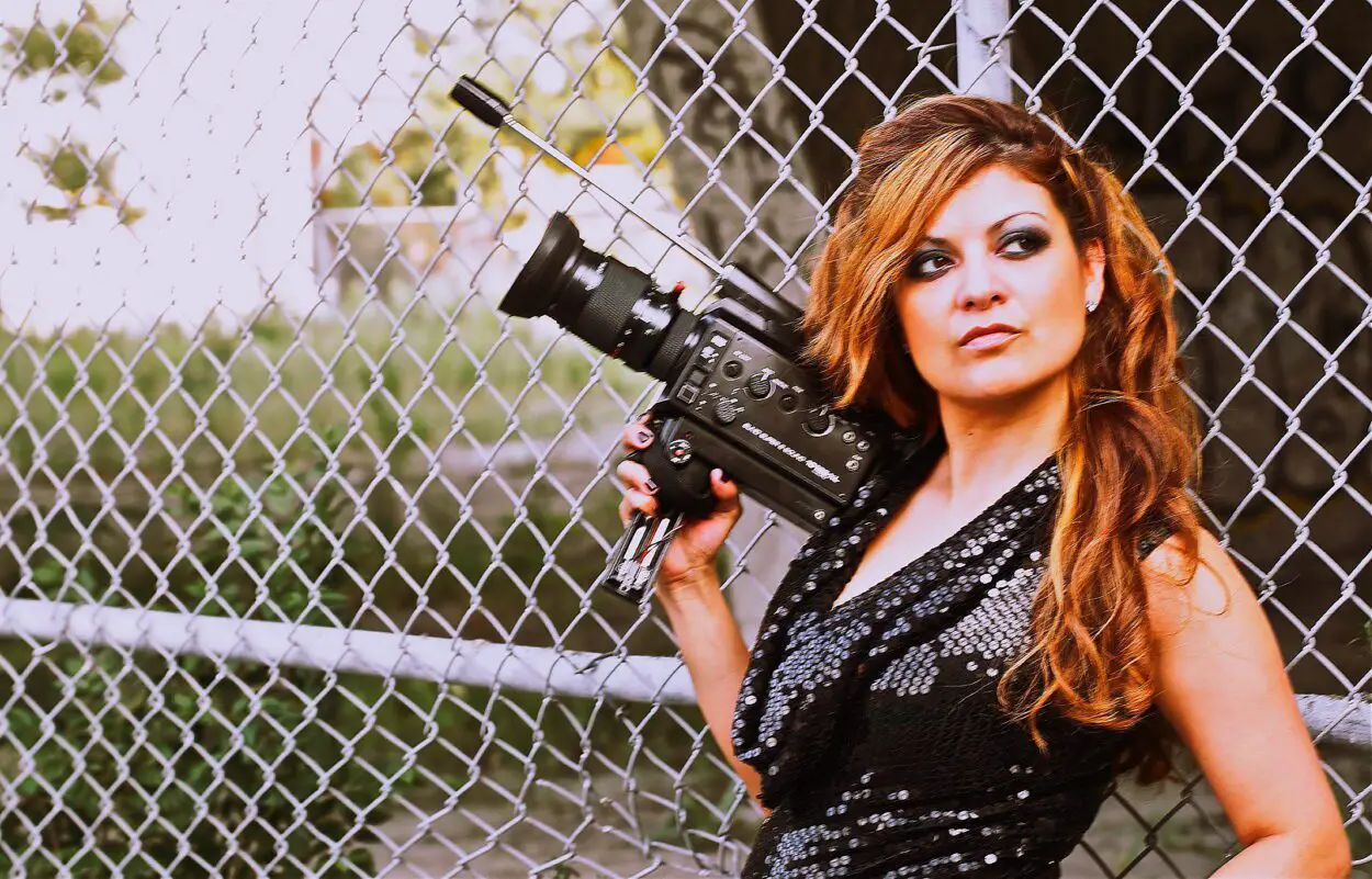 Director Patricia Chica of MONTRÉAL GIRLS holding a camera outside