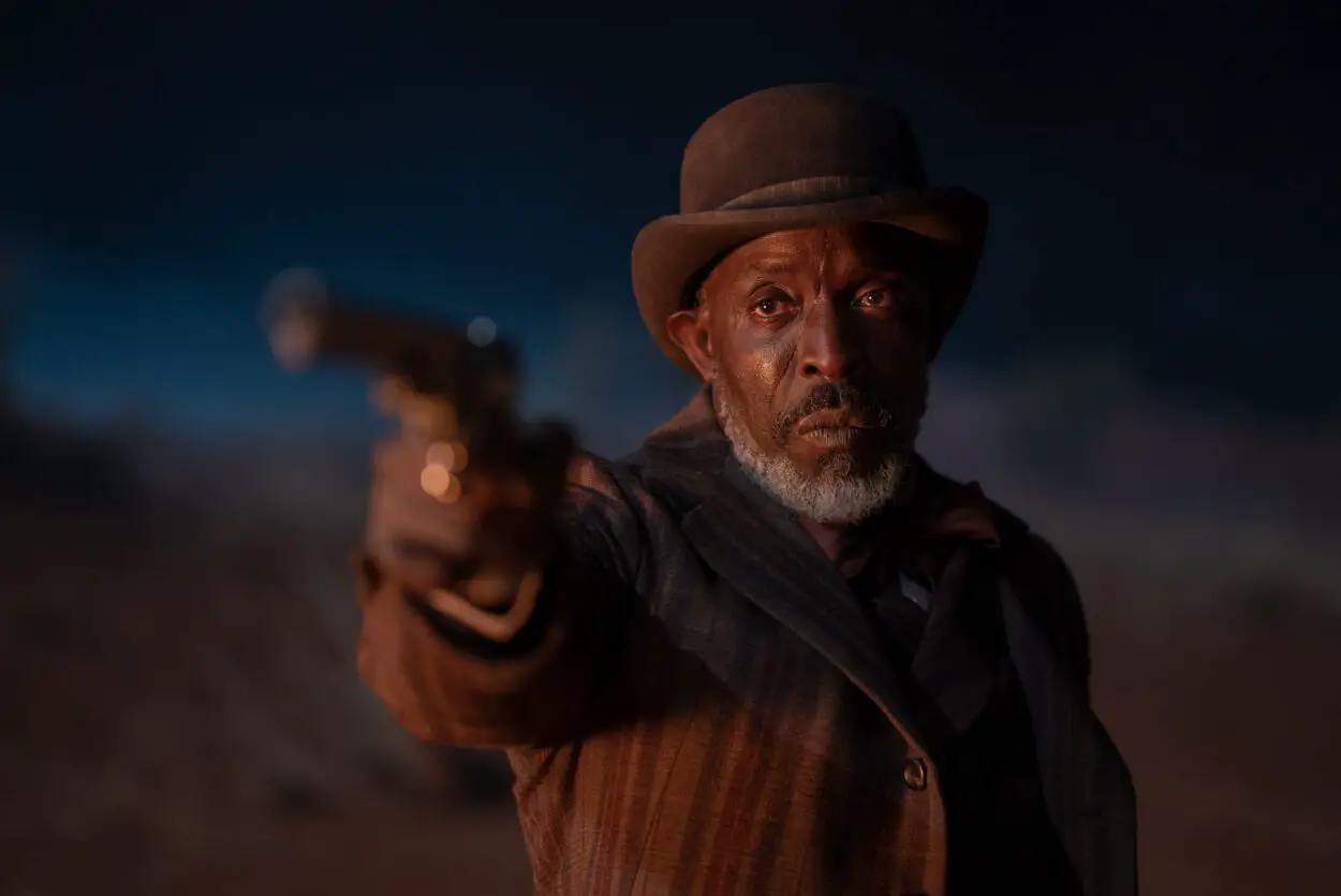 Still from SURROUNDED showing the character played by Michael K. Williams pointing a gun 