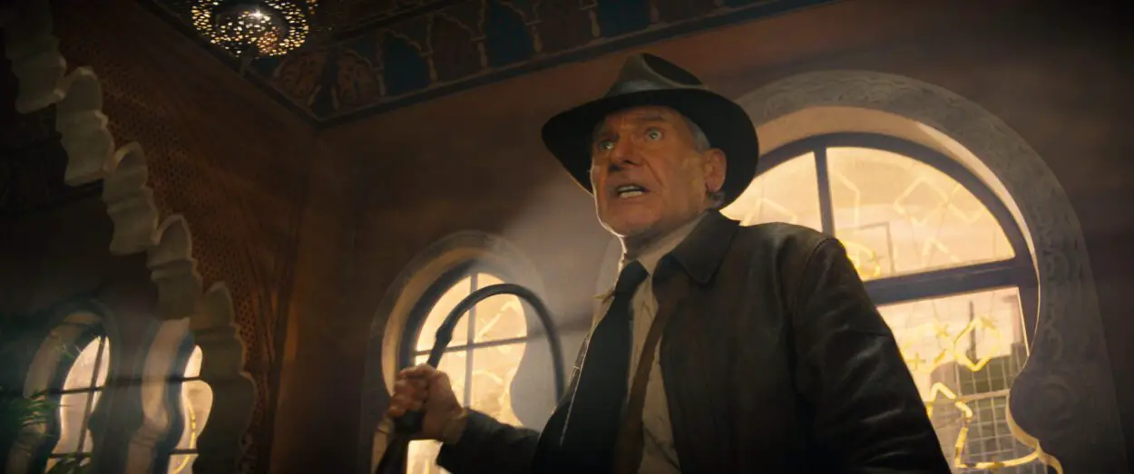 A man in a fedora brandishes a whip in Indiana Jones and the Dial of Destiny