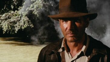 Indiana Jones steps forward from canopy shadows in Raiders of the Lost Ark