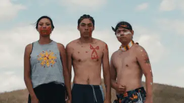 Medium shot showing three young people of the Oglala Lakota