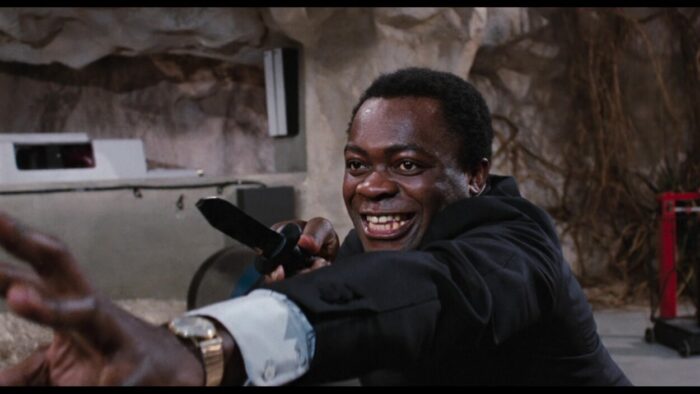Yaphet Kotto as Mr Big, wielding a knife against James Bond.