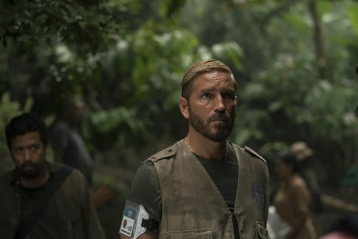 Jim Caviezel as Tim Ballard walking through a rainforest in Sound of Freedom.
