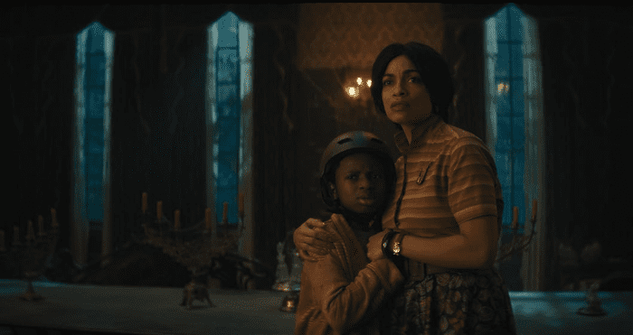 Haunted Mansion: r-l Travis (Chase Dillon) and Gabbie (Rosario Dawson) clinging to each other. 