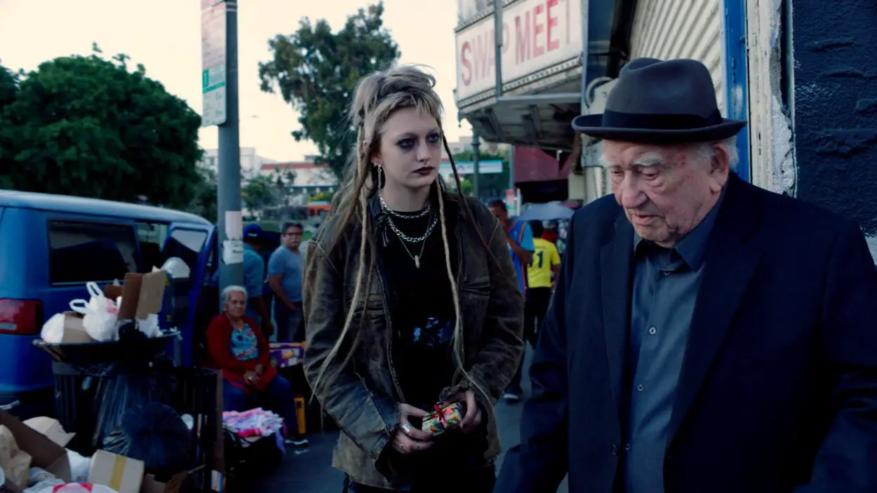 A young girl and an old man walk down a LA street in Tiger Within