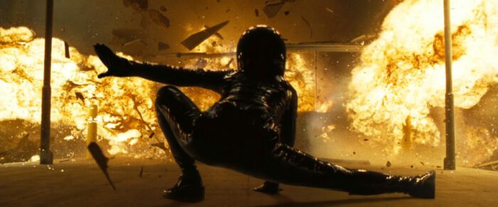 Trinity lands in front of an explosion at the start of The Matrix Reloaded