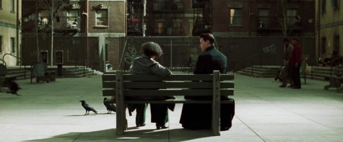 The Oracle and Neo on a bench in The Matrix Reloaded