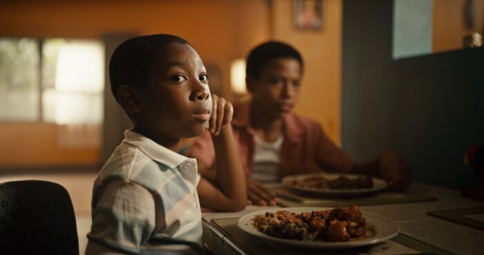 Young Francis and MIchael together at the dinner table.