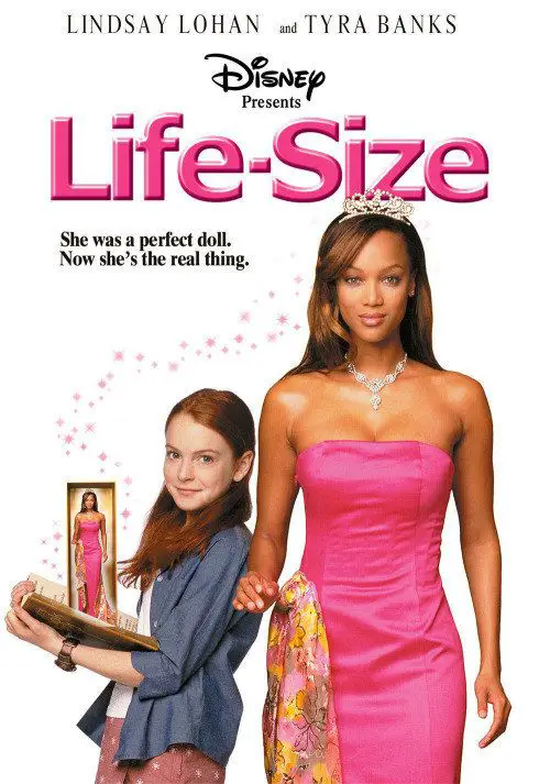 Casey (Lindsay Lohan) holds an "Eve" Doll while leaning against the life-size, living "Eve" Doll (Tyra Banks)