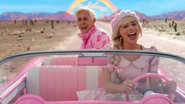 Two people ride in a pink convertible and sing together in Barbie.