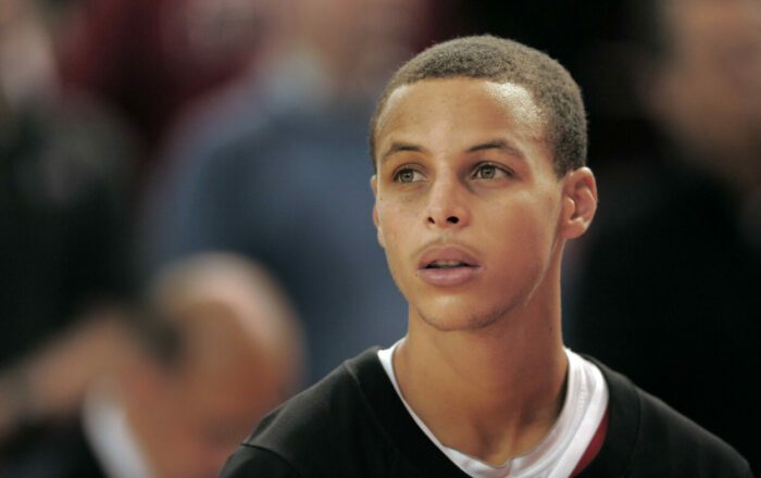 A young and noticeably small Stephen Curry on the basketball court.